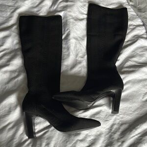 Elegant black sock boots that go up to the knee